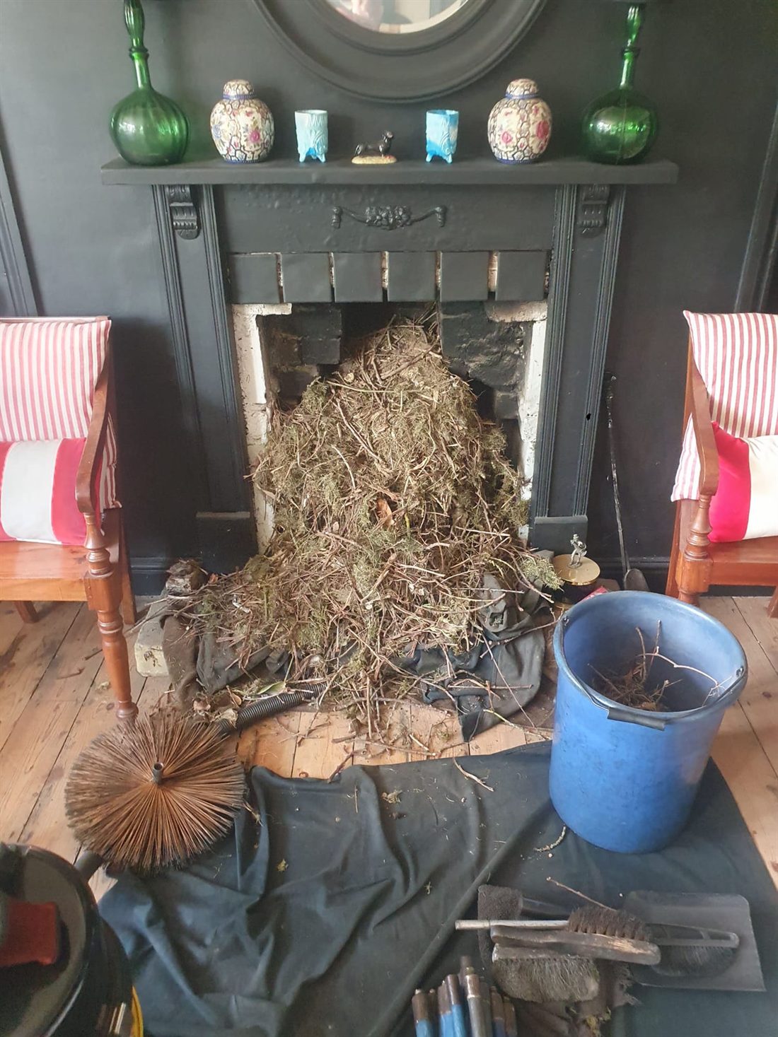 A large bird's nest removed from a blocked chimney and cleared into the hearth