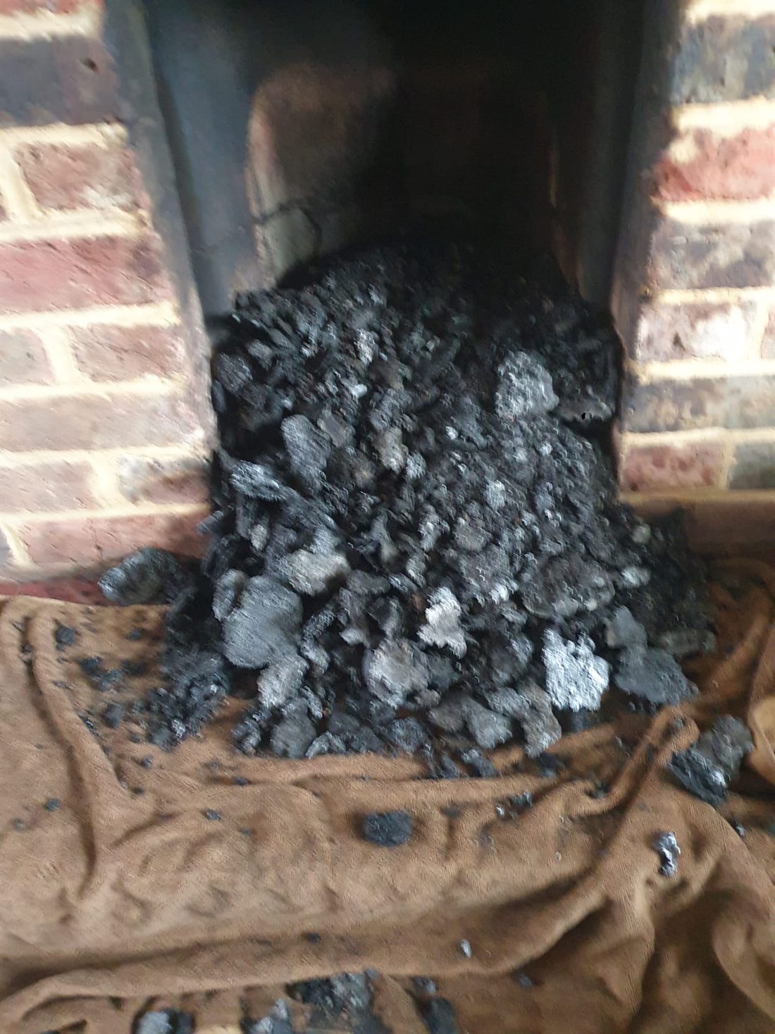 Burning tar and soot cleared from a flue after a chimney fire