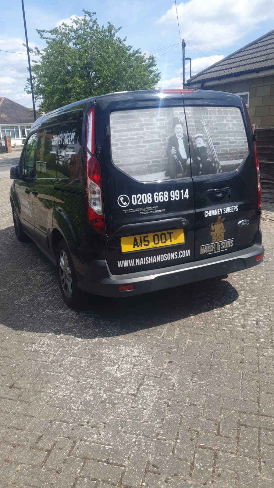 The black Naish & Sons chimney sweep van today, registration A15 OOT, with the family photograph in the rear window
